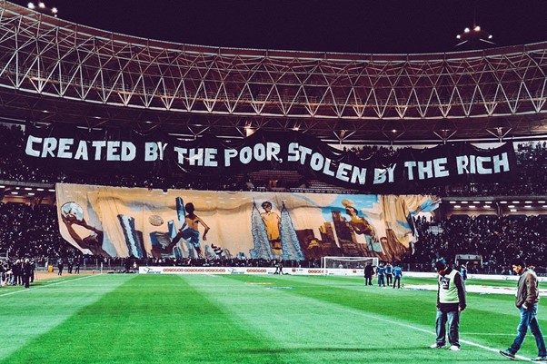 Football protest banner: created by the poor, stolen by the rich